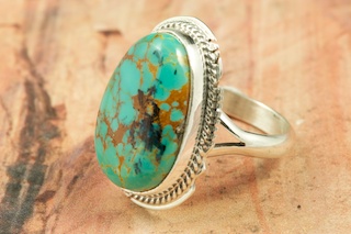 Genuine Manassa Turquoise set in Sterling Silver Ring. This Turquoise is also referred to as King�s Manassa Turquoise. The Manassa Turquoise mine is located in Manassa, Conejos County, Colorado. Created by Navajo Artist Larson Lee. Signed by the artist.